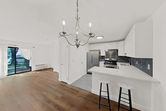 90 Ralph St Unit 3, Belleville, NJ 07109 - kitchen with appliances with stainless steel finishes, a sink, a peninsula, white cabinets, and light wood-style flooring