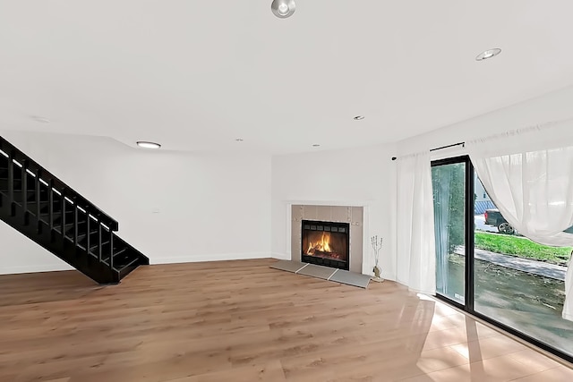 90 Ralph St Unit 3, Belleville, NJ 07109 - unfurnished living room featuring stairs, light wood-type flooring, a tile fireplace, recessed lighting, and baseboards