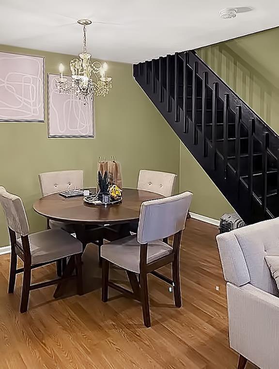 90 Ralph St Unit 3, Belleville, NJ 07109 - dining room with a chandelier, wood finished floors, baseboards, and stairs