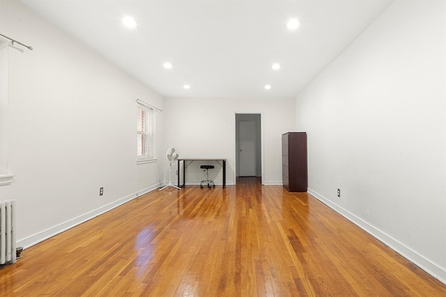 40 Glenwood Ave Unit C303, Jersey City, NJ 07306 - unfurnished living room with light wood-style floors, recessed lighting, and radiator heating unit