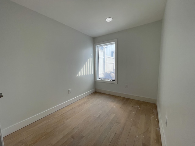 unfurnished room featuring light wood-type flooring and baseboards