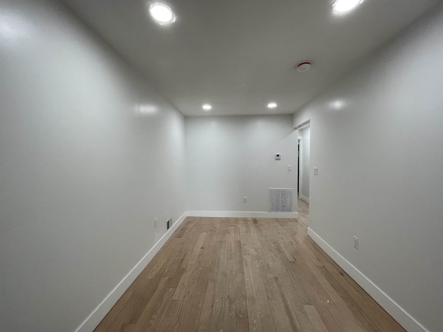 interior space featuring light wood-style flooring, visible vents, and baseboards