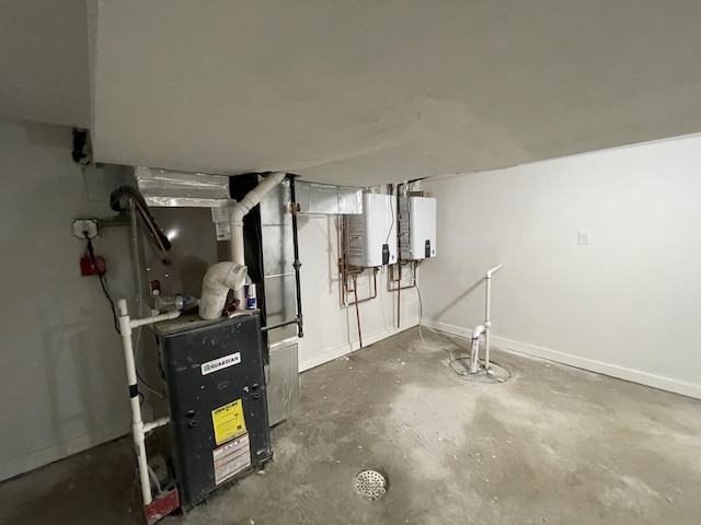 unfinished basement with heating unit, baseboards, and tankless water heater