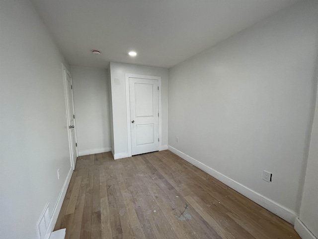 unfurnished room featuring baseboards, recessed lighting, visible vents, and light wood-style floors