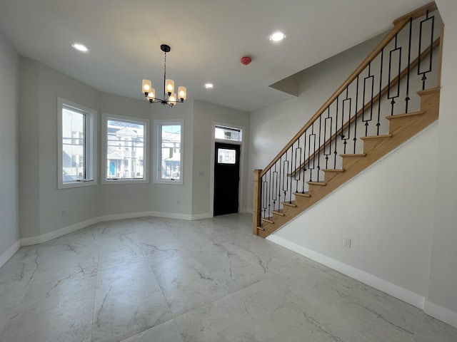 foyer entrance featuring marble finish floor, stairway, and baseboards