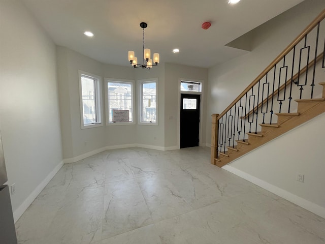 entryway featuring recessed lighting, marble finish floor, and baseboards