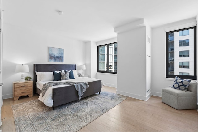 bedroom with baseboards and wood finished floors