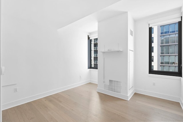 interior space with visible vents, baseboards, and wood finished floors