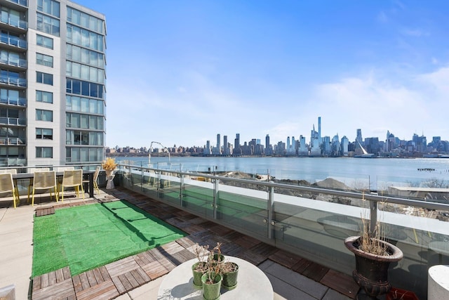 exterior space featuring a view of city, a water view, and a balcony