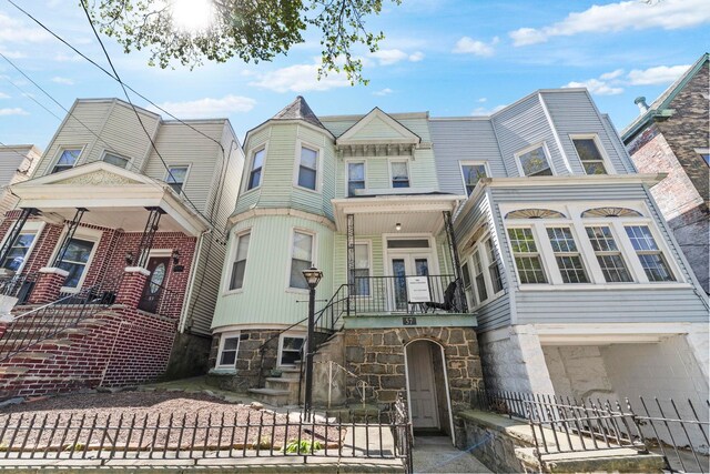 57 Booraem Ave, Jersey City, NJ 07307 - view of front of home with stone siding, stairs, and a garage