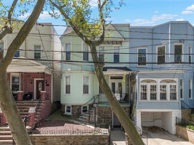 57 Booraem Ave, Jersey City, NJ 07307 - view of front facade with a garage and concrete driveway