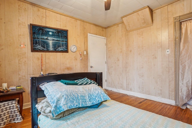 442 Avenue E Ave E, Bayonne, NJ 07002 - bedroom with wooden walls, wood-type flooring, baseboards, and ceiling fan