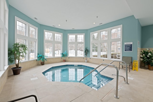 view of swimming pool featuring an indoor hot tub