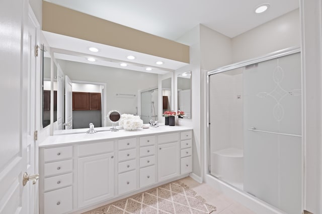 full bathroom with double vanity, a stall shower, tile patterned floors, a sink, and recessed lighting