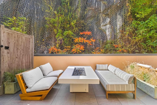 view of patio featuring an outdoor living space with a fire pit