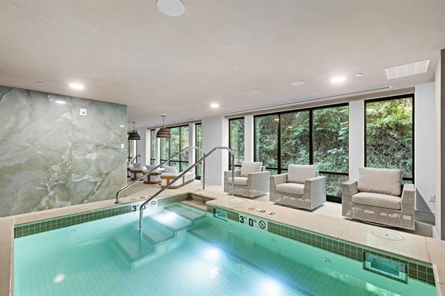 view of pool with an indoor hot tub