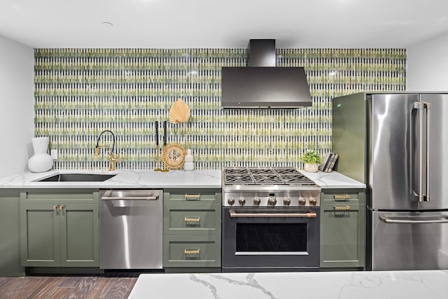 kitchen featuring light stone countertops, appliances with stainless steel finishes, sink, and wall chimney range hood