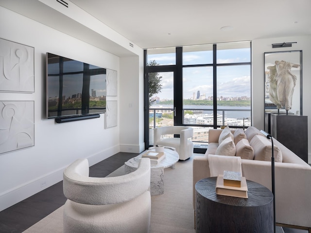 living room with dark hardwood / wood-style floors and floor to ceiling windows