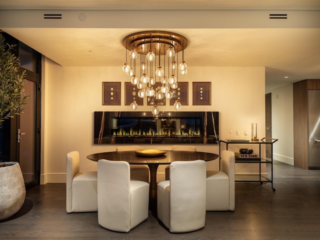 dining space featuring a chandelier and dark hardwood / wood-style floors