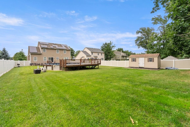 view of yard with a pool side deck and a storage shed