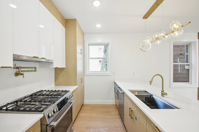 9 Pierce Ave Unit 2, Jersey City, NJ 07307 - kitchen featuring stainless steel appliances, under cabinet range hood, light wood-type flooring, light countertops, and white cabinetry
