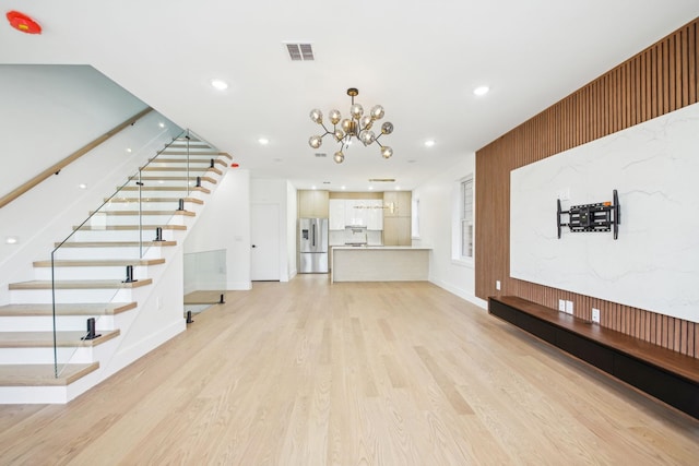 9 Pierce Ave Unit 2, Jersey City, NJ 07307 - unfurnished living room featuring stairs, light wood-style flooring, a chandelier, and recessed lighting