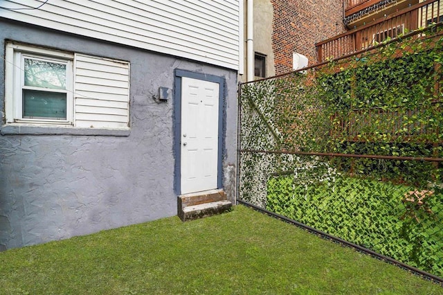property entrance with stucco siding