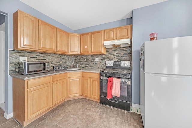 kitchen with black gas range, backsplash, light brown cabinetry, and white refrigerator