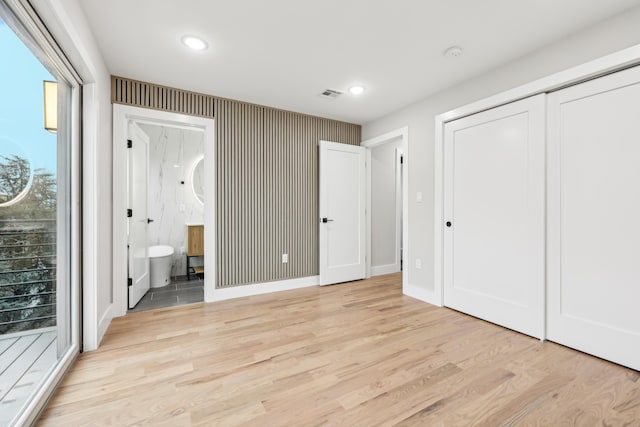 27 E 16th St, Bayonne, NJ 07002 - unfurnished bedroom featuring light wood-style flooring, recessed lighting, connected bathroom, baseboards, and a closet