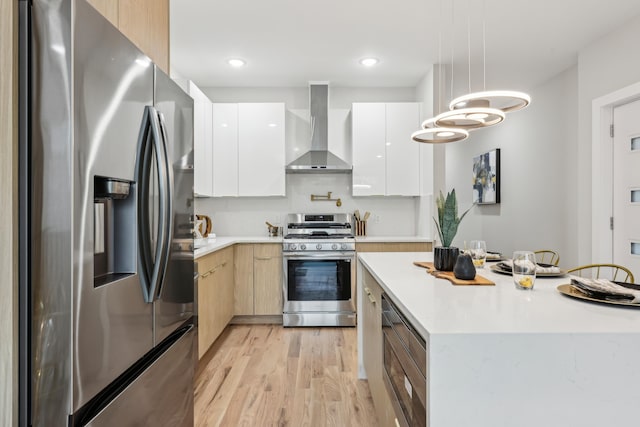 27 E 16th St, Bayonne, NJ 07002 - kitchen featuring stainless steel appliances, wall chimney exhaust hood, modern cabinets, light countertops, and recessed lighting