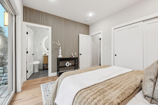 27 E 16th St, Bayonne, NJ 07002 - bedroom with light wood-style flooring, recessed lighting, a closet, and ensuite bathroom