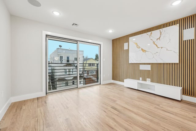 27 E 16th St, Bayonne, NJ 07002 - unfurnished room with wood finished floors, baseboards, recessed lighting, and wooden walls