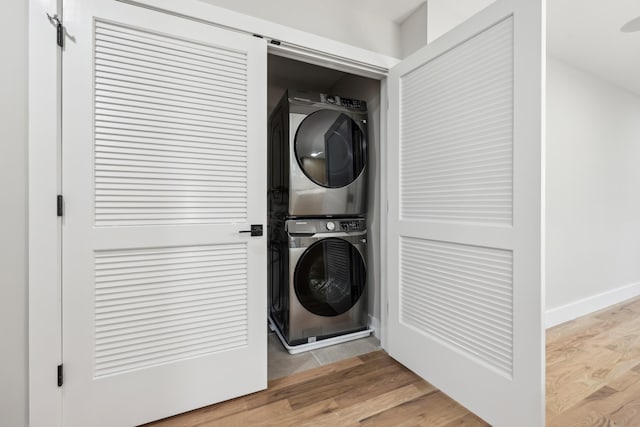 27 E 16th St, Bayonne, NJ 07002 - laundry area with estacked washer and dryer and wood finished floors