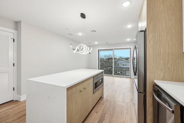 27 E 16th St, Bayonne, NJ 07002 - kitchen featuring appliances with stainless steel finishes, light wood-style floors, modern cabinets, a center island, and recessed lighting