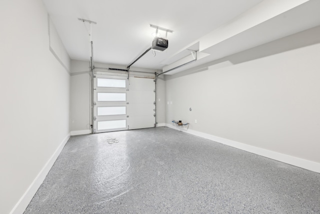 27 E 16th St, Bayonne, NJ 07002 - garage featuring a garage door opener and baseboards