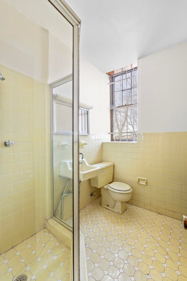 6 Kingswood Rd, Weehawken, NJ 07086 - full bathroom with tile walls, a shower stall, toilet, tile patterned floors, and wainscoting
