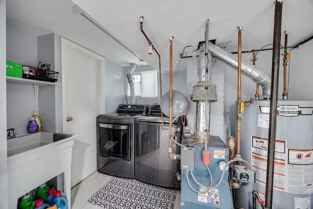 clothes washing area with a sink, water heater, separate washer and dryer, a heating unit, and laundry area