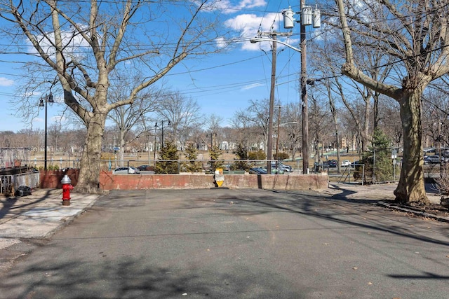 view of road with curbs, street lights, and sidewalks