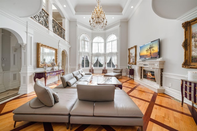 2 Euclid Rd, Fort Lee, NJ 07024 - living room with a high end fireplace, a decorative wall, arched walkways, a high ceiling, and a chandelier