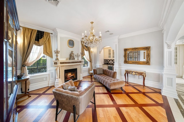 2 Euclid Rd, Fort Lee, NJ 07024 - living room featuring a lit fireplace, a chandelier, light wood-style floors, arched walkways, and crown molding