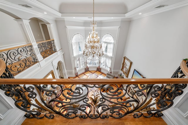 2 Euclid Rd, Fort Lee, NJ 07024 - stairs featuring arched walkways, ornate columns, a chandelier, a raised ceiling, and a towering ceiling
