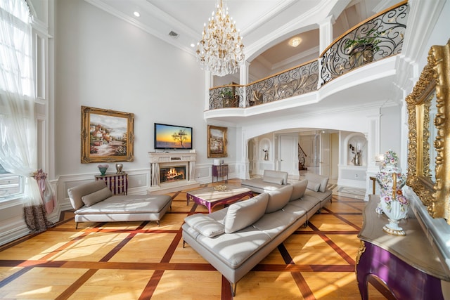 2 Euclid Rd, Fort Lee, NJ 07024 - living area with inlaid floor details, a high ceiling, a lit fireplace, arched walkways, and ornamental molding