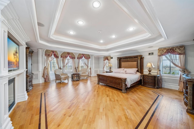 2 Euclid Rd, Fort Lee, NJ 07024 - bedroom featuring light wood finished floors, multiple windows, a glass covered fireplace, ornamental molding, and a decorative wall