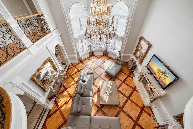 2 Euclid Rd, Fort Lee, NJ 07024 - living room with a towering ceiling, a chandelier, inlaid floor details, and ornate columns