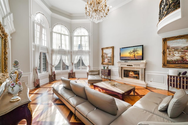 2 Euclid Rd, Fort Lee, NJ 07024 - living room featuring a towering ceiling, a chandelier, a glass covered fireplace, ornamental molding, and a wainscoted wall