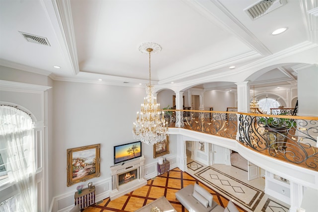 2 Euclid Rd, Fort Lee, NJ 07024 - living area with inlaid floor details, ornate columns, arched walkways, ornamental molding, and a chandelier