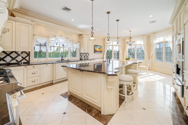 2 Euclid Rd, Fort Lee, NJ 07024 - kitchen featuring cream cabinetry, ornamental molding, a chandelier, a warming drawer, and stainless steel microwave