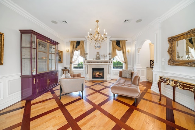 2 Euclid Rd, Fort Lee, NJ 07024 - living area with arched walkways, light wood-type flooring, a lit fireplace, crown molding, and a chandelier