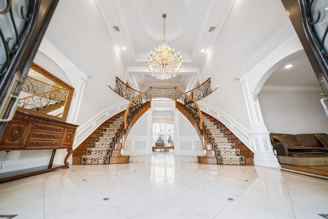 2 Euclid Rd, Fort Lee, NJ 07024 - tiled entryway with arched walkways, a high ceiling, stairs, a chandelier, and decorative columns
