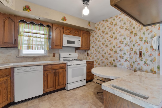 134 W 25th St, Bayonne, NJ 07002 - kitchen with white appliances, brown cabinetry, light countertops, a baseboard heating unit, and wallpapered walls